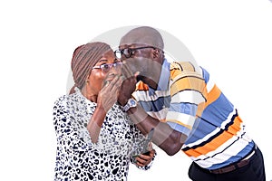 Adult man whispering an interesting secret in a woman`s ear