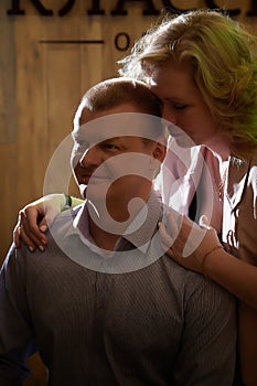 Adult man and woman are conversing on stage in a dimly lit room before a performance or interview. The actors, actress