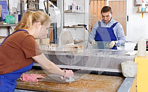 Adult man and woman working on washing machine