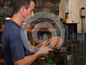 Adult man working in a shoe factory