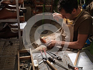 Adult man working in a shoe factory