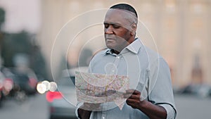 Adult mature black foreign tourist look for address lost african american man traveler in new city standing on street