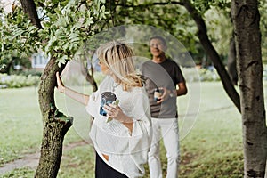 An adult mature happy couple in love hugging outdoors in city park. A blonde caucasian man and woman spend time together