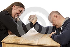 Adult men are engaged in armwrestling. Close-up, isolated on white background