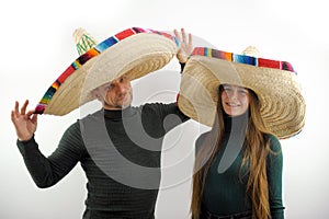adult man and young girl hold on their heads sombrero hat spanish headdresses joy buy at time in dark green golfs on a photo