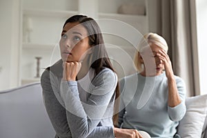Adult mom and daughter having misunderstanding at home photo