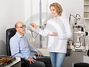 Adult optician examinating eyesight