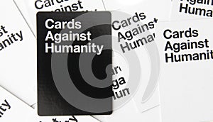 Adult party game cards against humanity scattered white and black cards