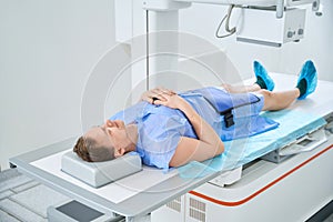 Man getting knee x-ray with digital radiography equipment photo