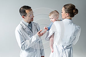 adult pediatricians with adorable little baby photo