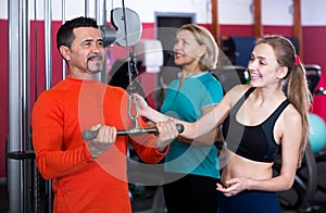 Adult people having strength training in gym