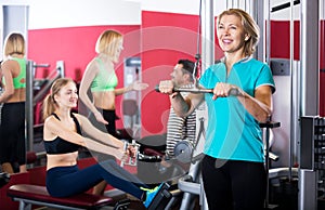 Adult people having strength training in gym