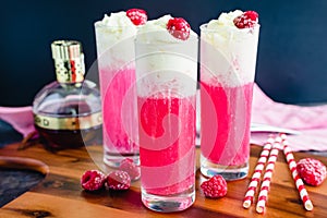 Raspberry Italian Cream Sodas Made Topped with Whipped Cream and Frozen Raspberries photo