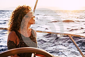 Adult rich woman enjoy luxury lifestyle traveling on sailboat yacht for summer holiday vacation - pretty female people outdoor