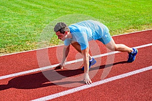 Adult runner prepare race at stadium. How to start running. Sport tips from professional runner. Man athlete runner