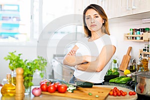 Adult sad latino woman tired of worries at kitchen