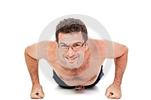 Adult smiling man doing workout pushups isolated