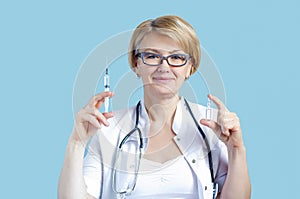 Adult smiling woman doctor with stethoscope holds syringe, ampoule