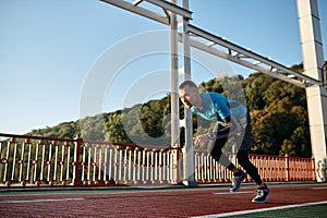 Adult speed runner running on racetrack