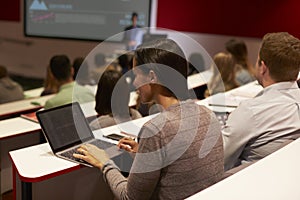 Adult student using laptop computer at a university lecture photo