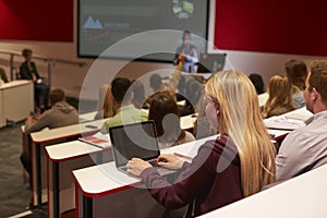 Adult student using laptop computer at a university lecture