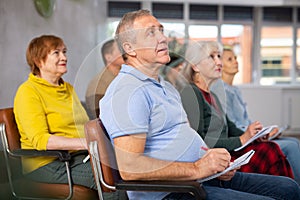 Adult students listening in classroom university