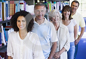 Adult students standing in a library photo