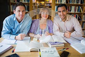 Adult students studying together in the library