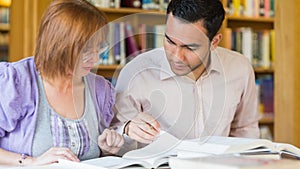 Adult students studying together in the library