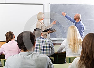 Adult students with teacher in classroom