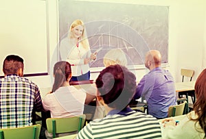 Adult students with teacher in classroom