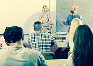 Adult students with teacher in classroom