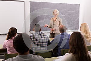 Adult students with teacher in classroom