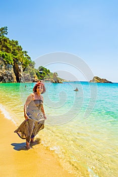 Adult tourist woman enjoying Platis Gialos Beach Kefalonia Greece