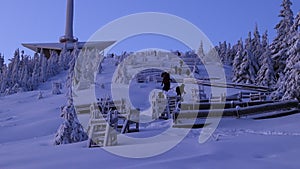 Adult tourists climbs to wonderful red communications tower in morning times. People hikes on the top of mountain because of they