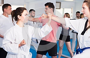 Adult trainees show their skills in training on karate
