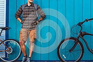 Adult Traveler Man Stands With A Bicycles Near Blue Wall Daily Lifestyle Urban Resting Concept