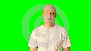 Adult white caucasian man gestures with green screen. Looking up thinking threaten fist hand finger. Upper half close-up