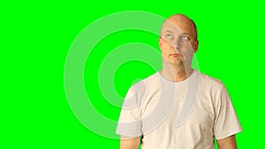 Adult white caucasian man gestures with green screen. Looking up thinking threaten fist hand finger. Upper half close-up