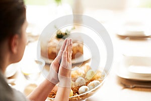 Adult woman blessing Easter food at home