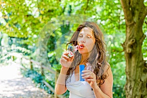 Adult woman blowing soap bubbles