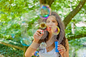 Adult woman blowing soap bubbles