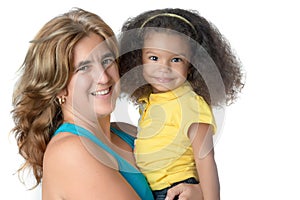 Adult woman carrying a cute afroamerican girl