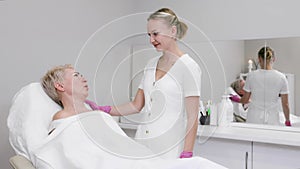 An adult woman at a cosmetologist's appointment in a beauty salon. Slow motion. The concept of professional cosmetology