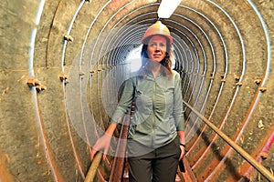 Adult woman descending into an underground tunnel