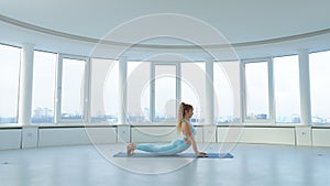 Adult woman doing yoga pose sequence indoor in front of the window