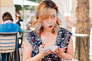 Adult woman eating sweets and smiling, skipping diet