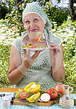 The adult woman eats vegetables salad photo