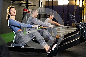 Adult woman exercising on rowing machine