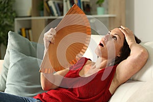 Adult woman fanning suffering heat stroke at home photo